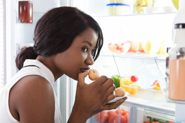 istock Close-up Of A Woman Eating Cookie 909314006