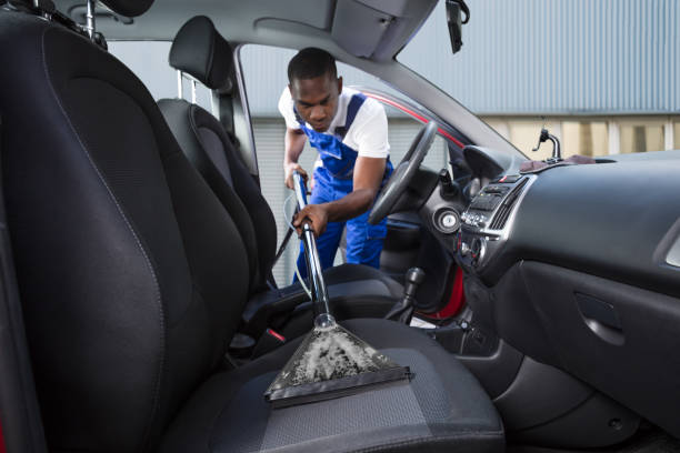 istock Handyman Vacuuming Car Front Seat 909314564