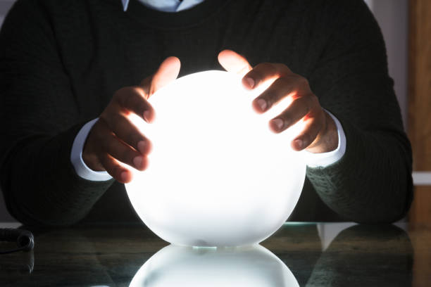 istock Businessman Hands On Crystal Ball 909314696
