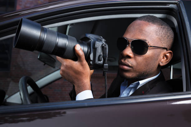 istock Detective Sitting Inside Car Photographing 909314728