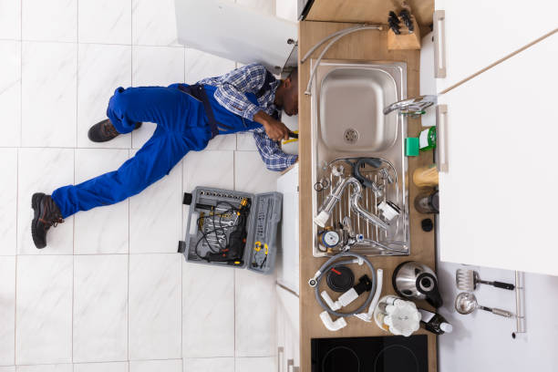istock Handyman Lying On Floor Repairing Sink 909317026