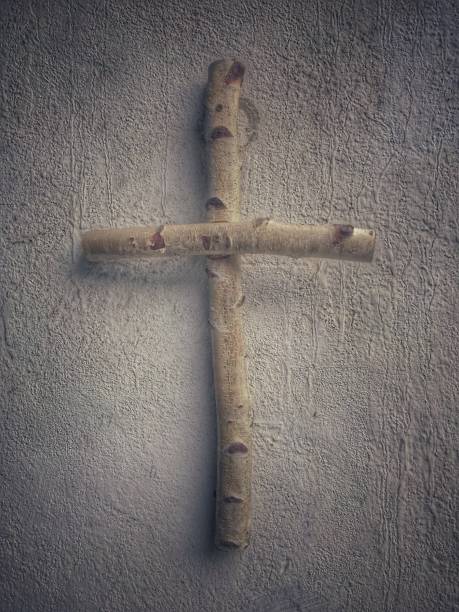 Wooden cross from a birch tree hanging on a wall.