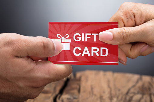 Close-up Photo Of Hands Exchanging Gift Card