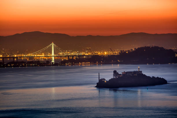 new bay bridge e alcatraz island a san francisco - bay bridge car traffic transportation foto e immagini stock