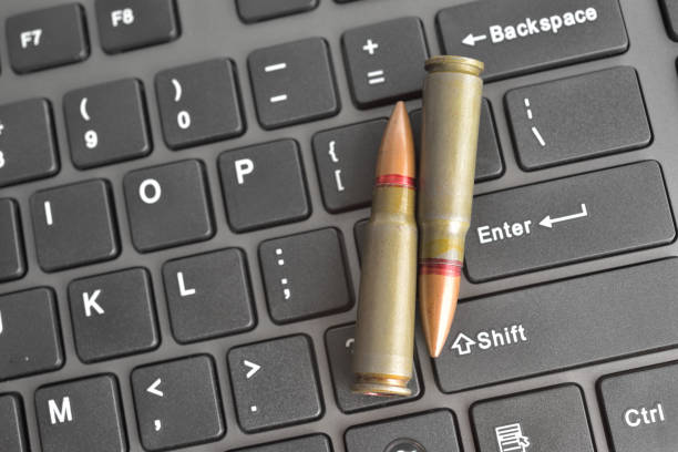 istock Internet dangers concept. Close up of bullets on computer keyboard 909321450