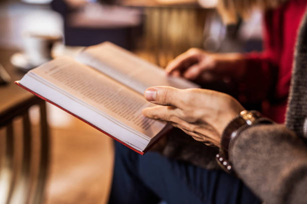 istock Close-up of young couple reading a book. 909324610