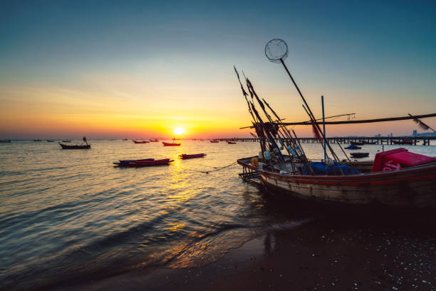 istock Fishing boat at sunset 909325420