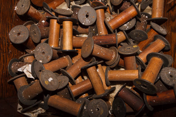istock Pile of Old Wooden Spools 909325486