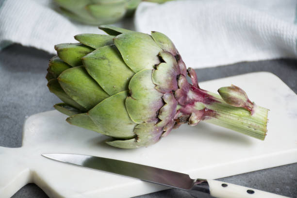 istock Green ripe raw artichokes ready to cook 909328754