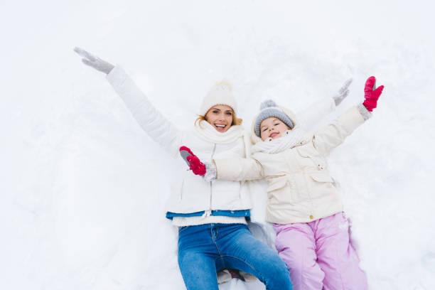 istock mother and daughter with open arms smiling at camera 909342886