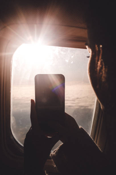 istock Taking photos through the window of the plane 909343000