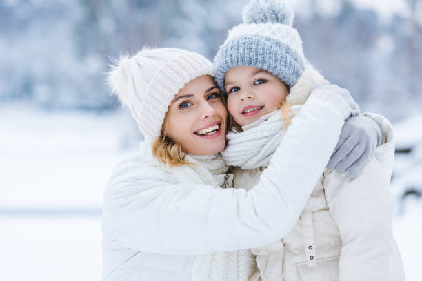 istock happy mother and daughter hugging and smiling at camera 909343138