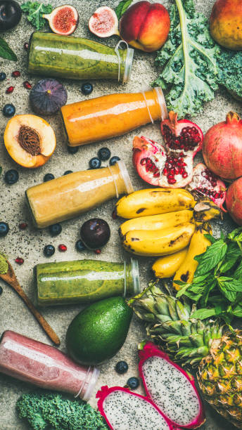 istock Colorful smoothies in bottles with fresh tropical fruit, top view 909348938