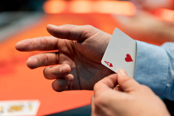Man with an ace under his sleeve at the casino Close-up on a man with an ace under his sleeve while playing poker at the casino ace photos stock pictures, royalty-free photos & images