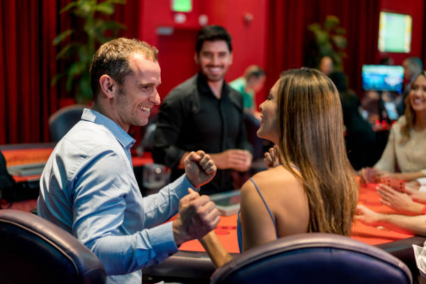 istock Happy couple winning while gambling at the casino 909349268