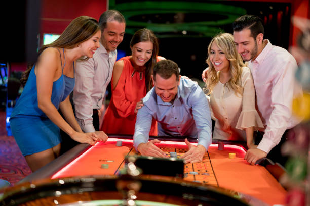 Five friends cheer and get excited as they win at the casino.