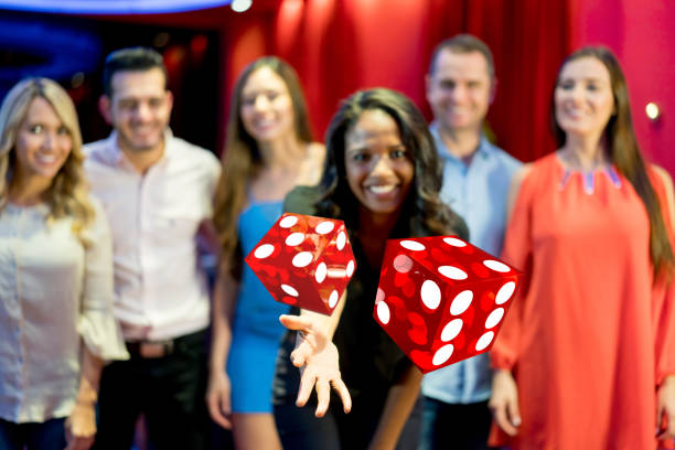 Woman throwing the dice while playing roulette at the casino