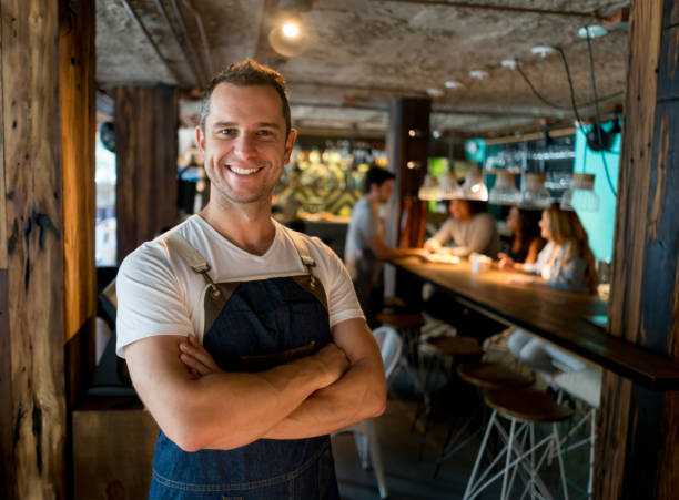 istock Happy business owner working at a restaurant 909349368