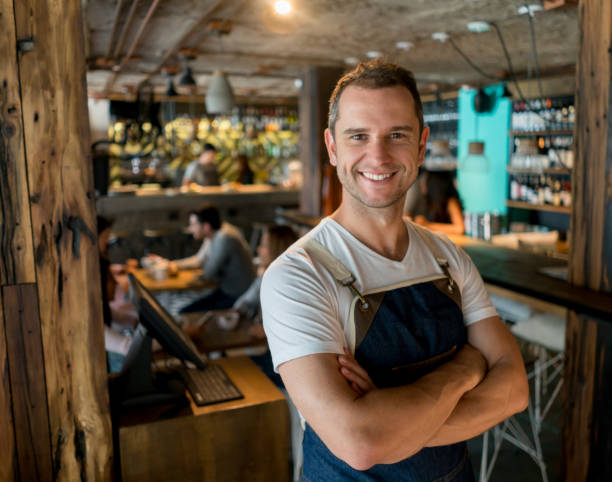 istock Happy waiter working at a restaurant 909349370