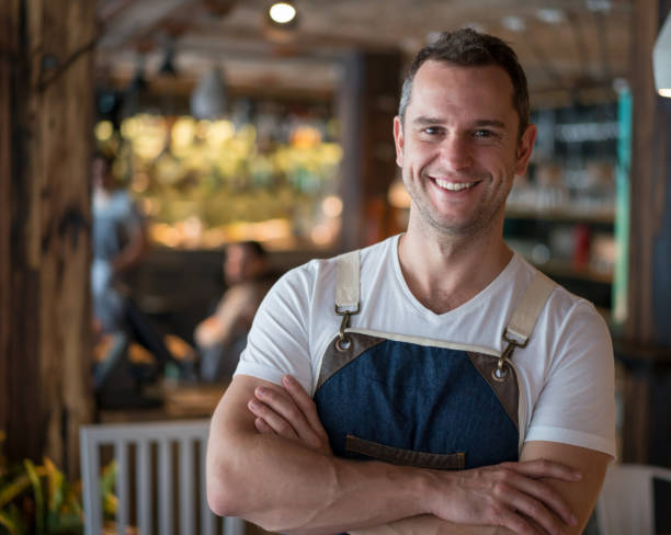 istock Happy waiter working at a restaurant 909349460