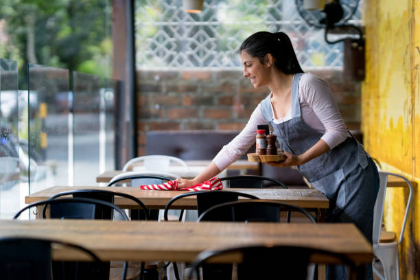 istock Waitress cleaning the tables at a restaurant 909349474