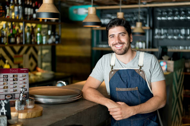 istock Happy business owner working at a restaurant 909349514