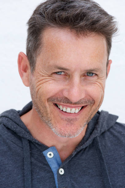 istock Close up handsome older man smiling isolated on white background 909350284