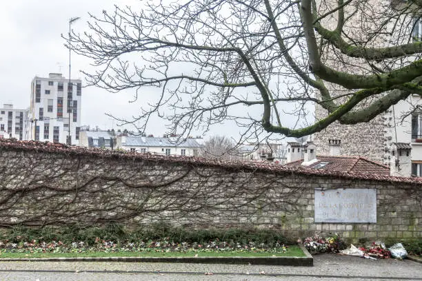 Picture of Communards Wall in Paris, France, during a cold winter afternoon. The Communards Wall (Mur des Federes) is the place where Commune combattants have been executed in 1871, and is now considered to be a symbol of French communism and socialism trends of the left wing."n