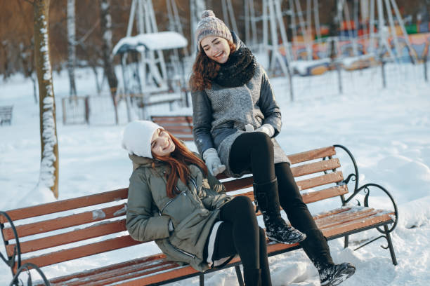 istock Girls sit on a bench 909350688