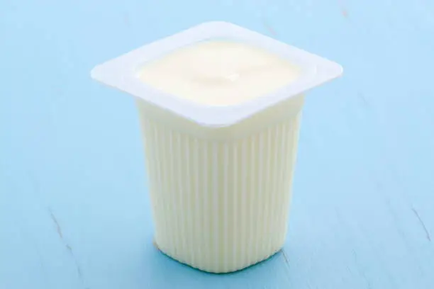 Delicious, nutritious and healthy fresh plain yogurt cup. On vintage retro styling.