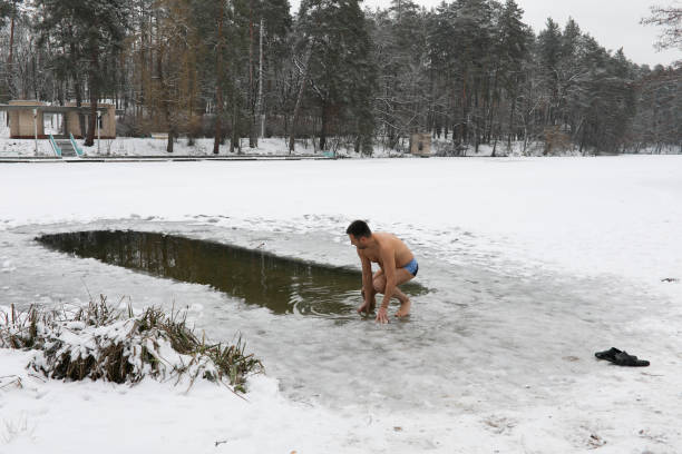 istock Bathing in the ice-hole in  Epiphany Day. 909356724