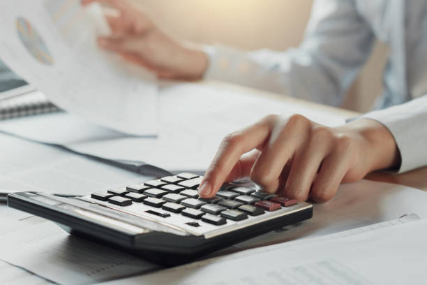 istock businessman using calculator for calculate budget on table in office. concept finance and accounting 909357340