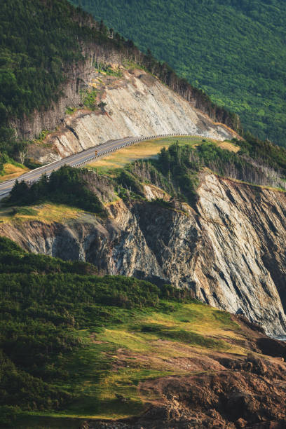 Cabot Trail highway cliff A close-up view of a highway cut through a cliff along the Cabot Trail. cabot trail stock pictures, royalty-free photos & images