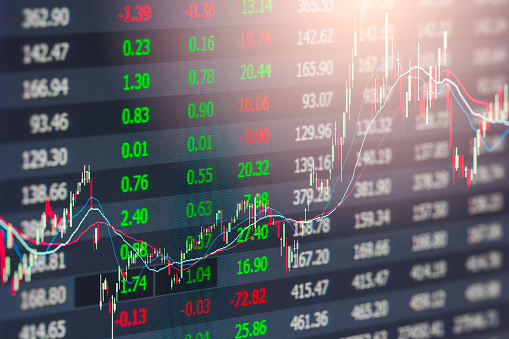 Red and green arrows moving in opposite directions over stock market data background. Horizontal composition with copy space. Volatility in Global Stock Markets.