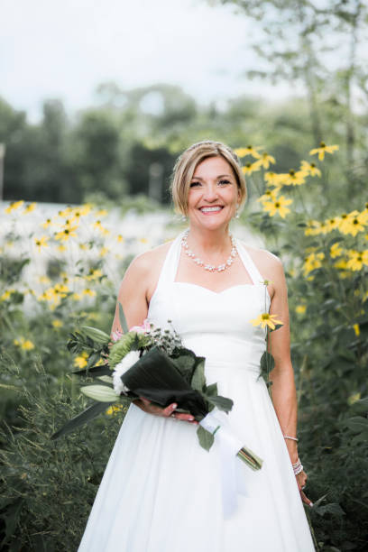 istock Beautiful and happy bride in a parc 909364176