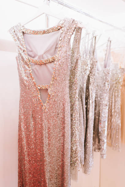 istock Luxury sparkling women's dresses on hangers 909364220