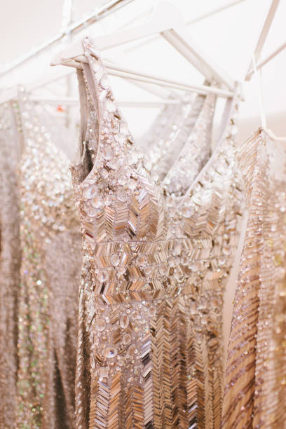 istock Luxury sparkling women's dresses on hangers 909364234