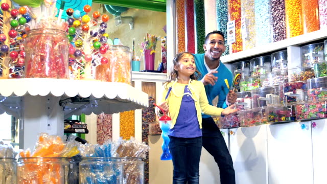 Family with two children excited to be in candy store