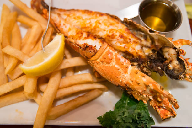 istock Lobster and potato chips on plate 909373818