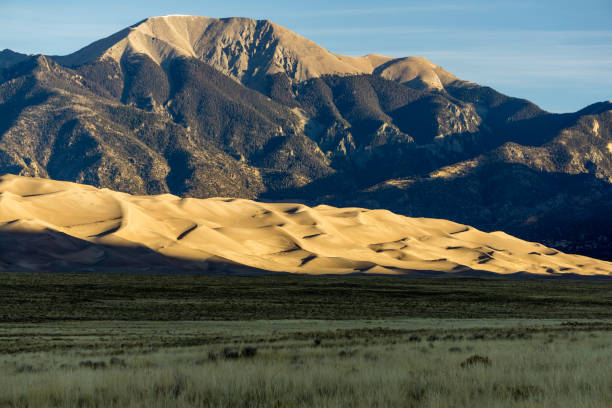 Great Sand Dunes National Park Early morning sunlight on the famous dune field near Alamosa, Colorado. great sand dunes national park stock pictures, royalty-free photos & images
