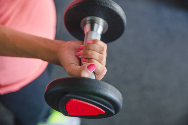 Females hand lifting a dumbbell