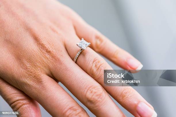 Macro Closeup Of Princess Cut Diamond Engagement Ring On Womans Female Hand Showing Detail And Texture Stock Photo - Download Image Now