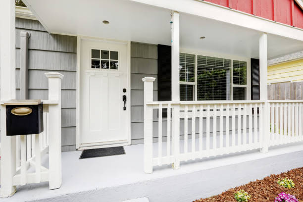 istock Welcoming front porch boasts pure white front door. 909377952