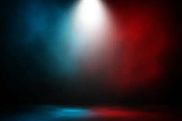 Photo of Spotlight fight and match red and blue smoke background.