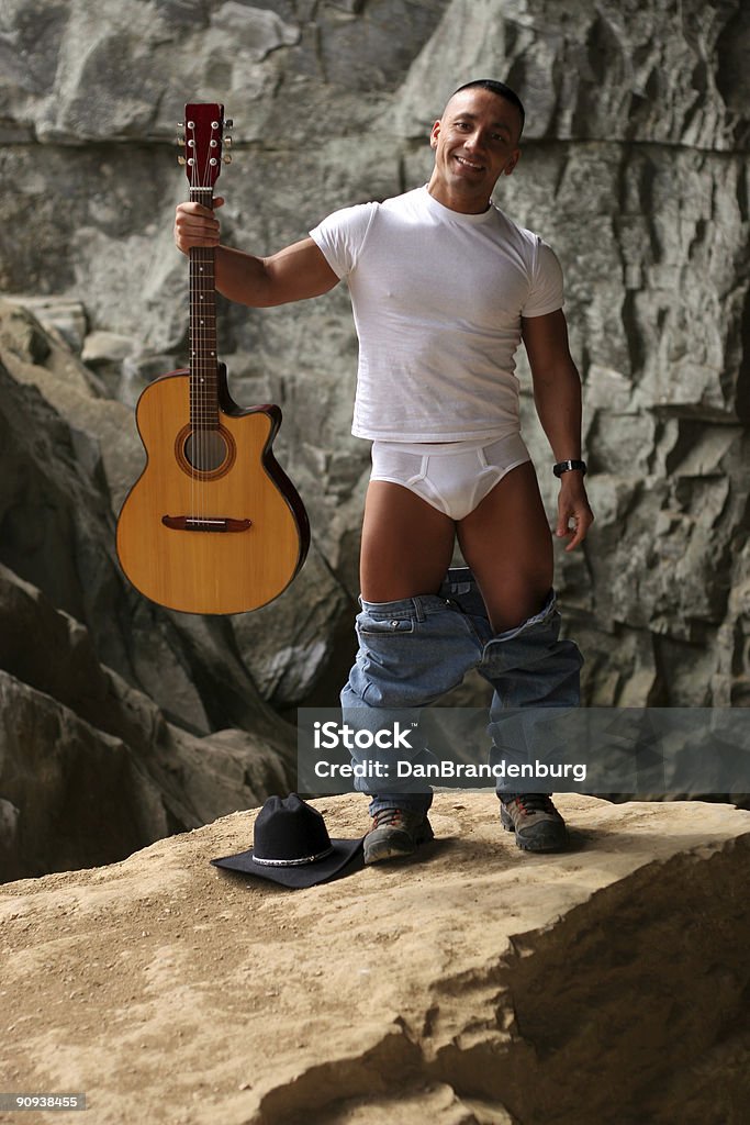 Guitar Cowboy in Underwear we're not sure why he's standing on a rock in his underwear holding a guitar -- perhaps you can tell me Cowboy Stock Photo