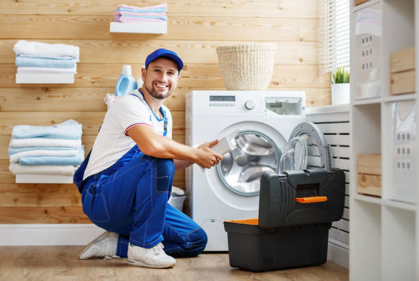 istock working man   plumber repairs  washing machine in   laundry 909392282