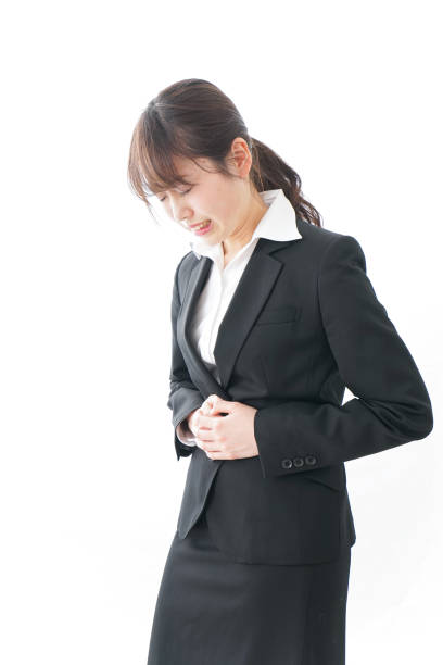 istock businesswoman suffering from stomachache 909395764