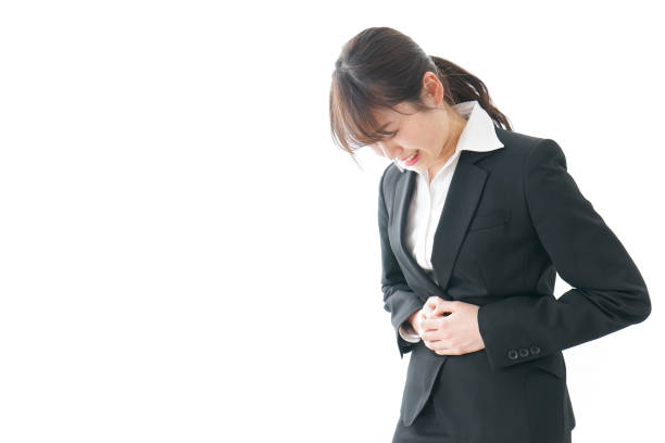 istock businesswoman suffering from stomachache 909395772