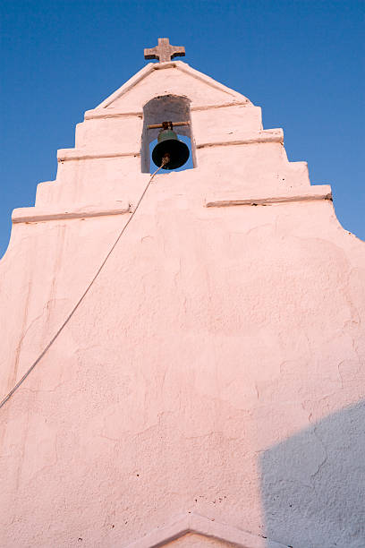 istock White stucco church facade and bell 90939615