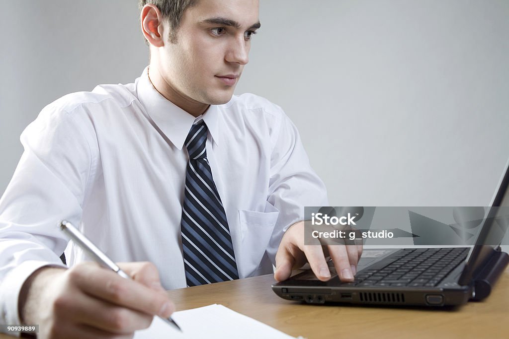 Young businessman or student at the table with laptop  Adult Stock Photo